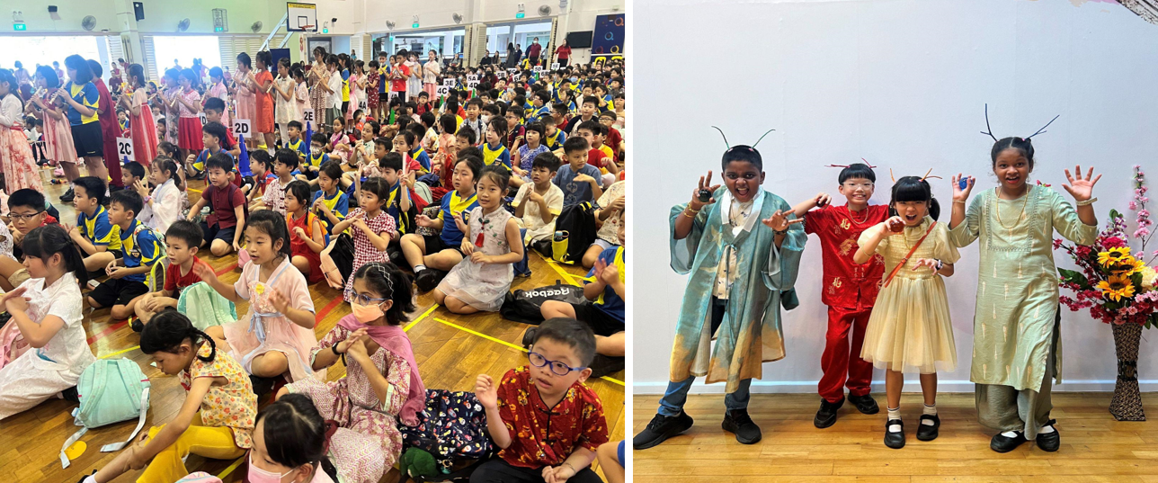 Children in traditional costumes at a school celebration; four kids pose playfully with antennae headbands beside flowers.