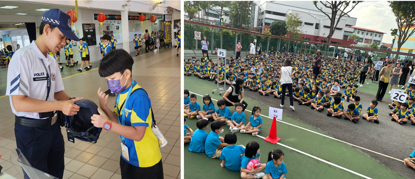 A police officer shows a helmet to a school child indoors, while hundreds of students in blue and yellow uniforms sit outdoors.