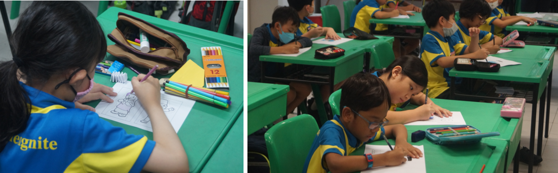 Children in blue and yellow uniforms sit at green desks, drawing and writing on paper with colored pencils.