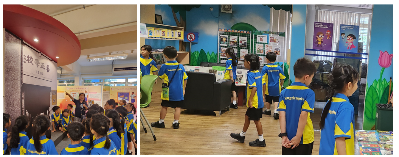 Children in blue and yellow uniforms on a school field trip, listening to a guide inside a museum exhibit.