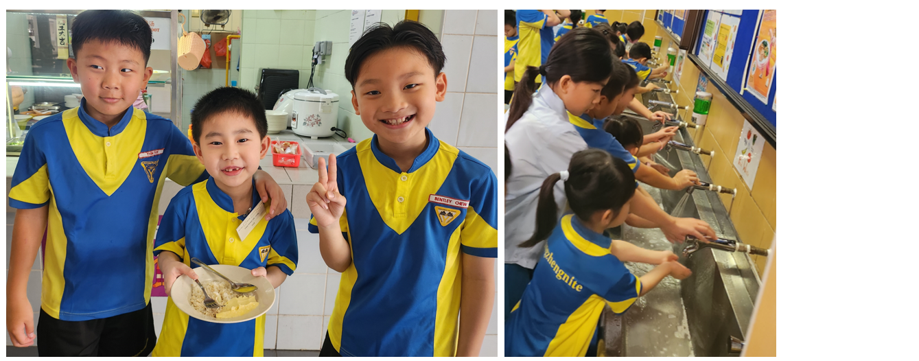 Three boys in blue and yellow uniforms pose with food, while other students wash hands at a row of sinks.