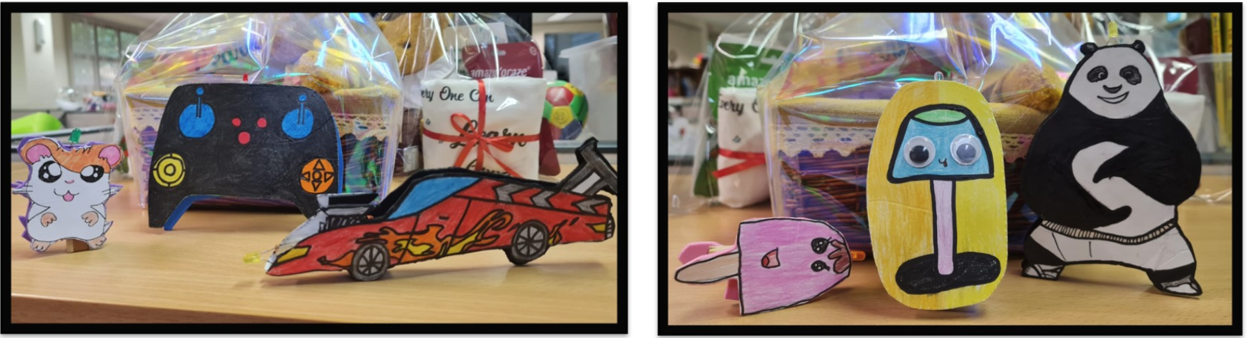 Hand-drawn paper cutouts of cartoon characters including a hamster, race car, panda, and mushroom on a table with gift baskets.