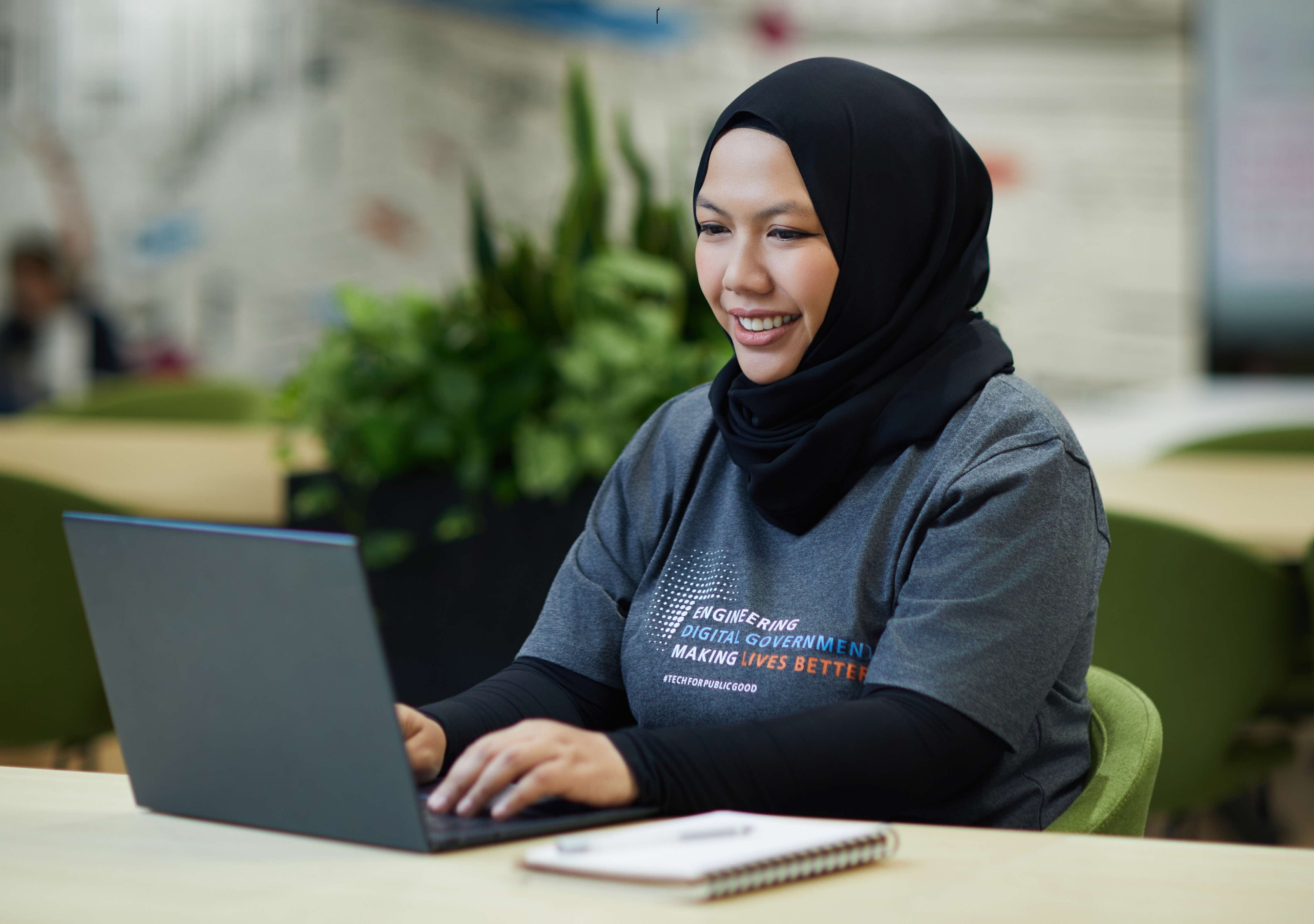 Image of staff working on laptop