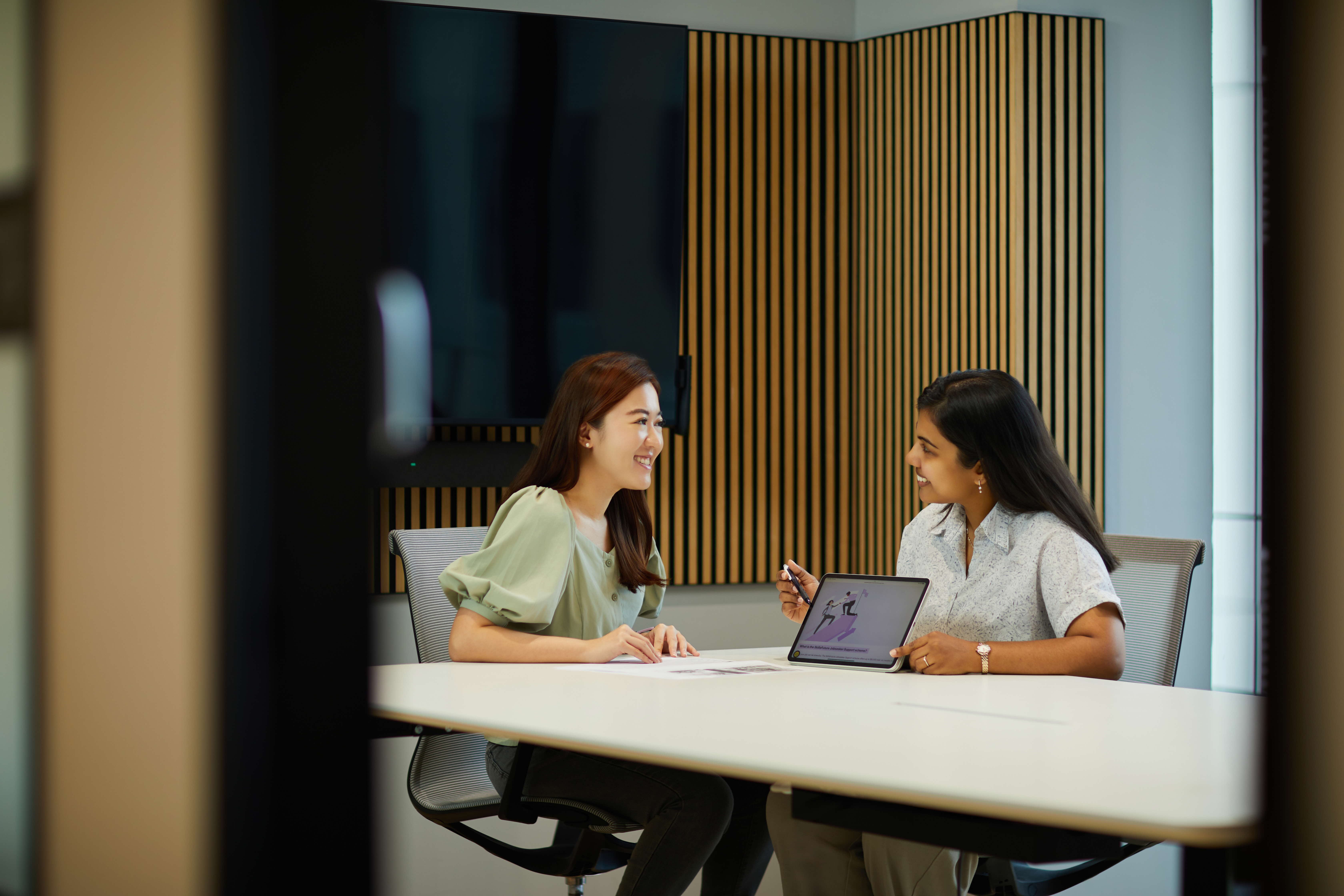 Image of 2 persons discussing citizen services