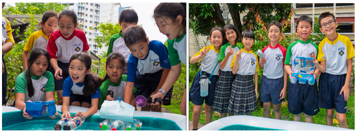 Young students in uniforms gather around a water tub testing floating craft made from bottles outdoors.