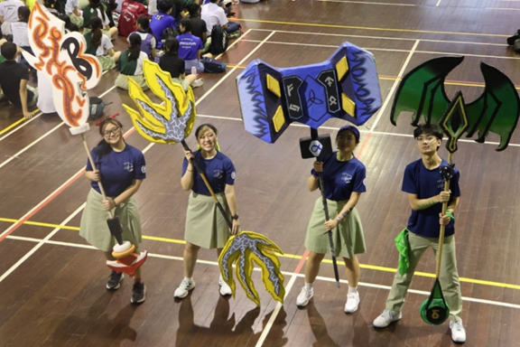AStudent Councillors holding up their hand-crafted House weapons.dd your alt text here