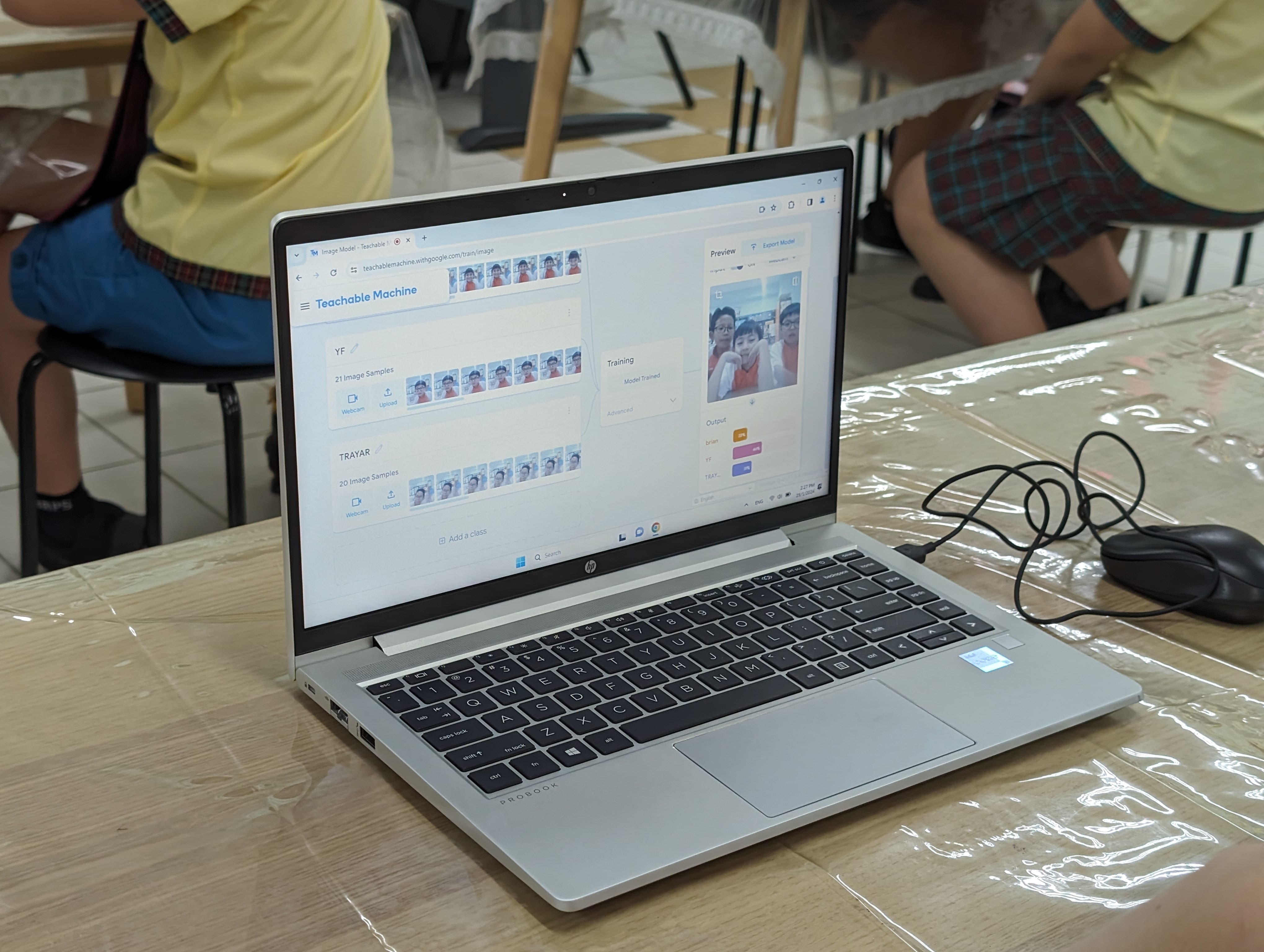 HP ProBook laptop on a desk showing Google's Teachable Machine website with student face samples and a live camera preview.