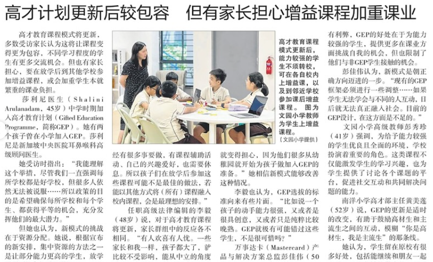 A teacher stands at a table where several young students sit and work together in a classroom setting.