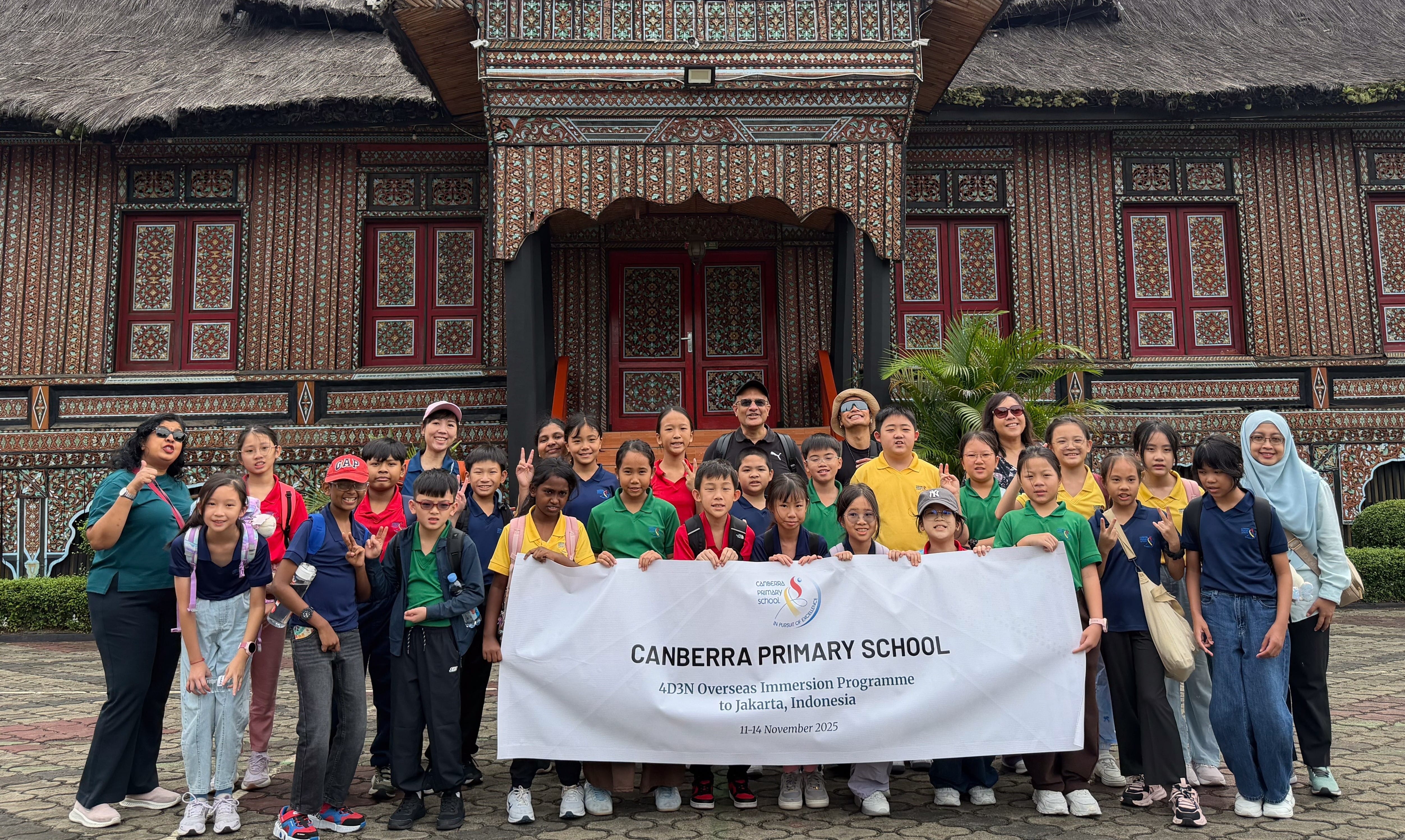 Canberra Primary School students and teachers gathered in front of a traditional house at Taman Mini Indonesia Indah. 