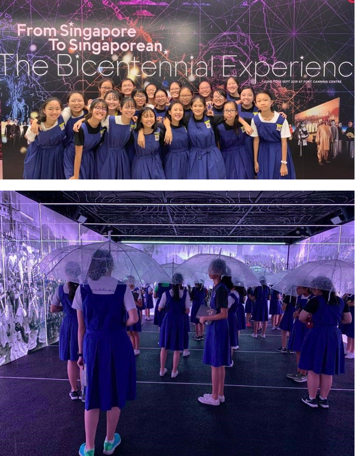 Students in blue uniforms pose at The Bicentennial Experience exhibit, and explore an immersive room holding clear umbrellas.