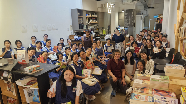 PUBS members group photo holding books at bookstore visit.