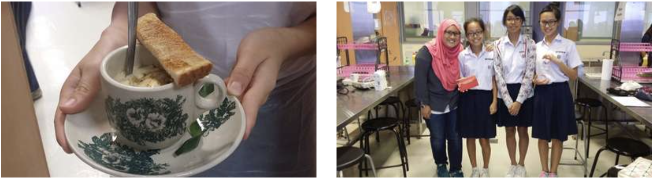 A cup with toast being stirred beside four girls smiling together in a school canteen setting.
