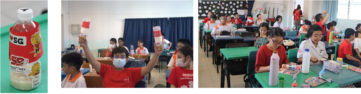 Students in a classroom hold up decorated bottles with Singapore SG59 stickers during a school activity.