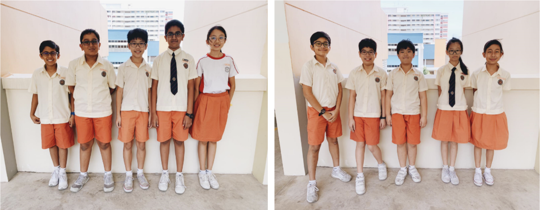 Two groups of school children in white shirts and orange shorts or skirts pose outdoors near a building.