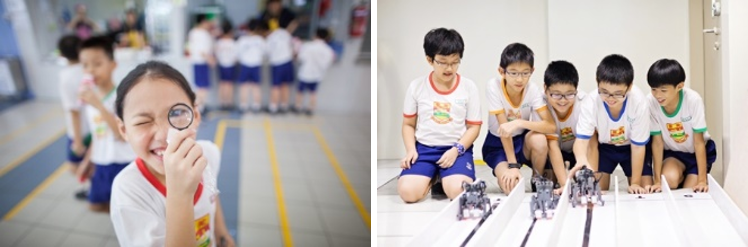 A girl peers through a magnifying glass smiling, while five boys in uniform watch small robots on a track.