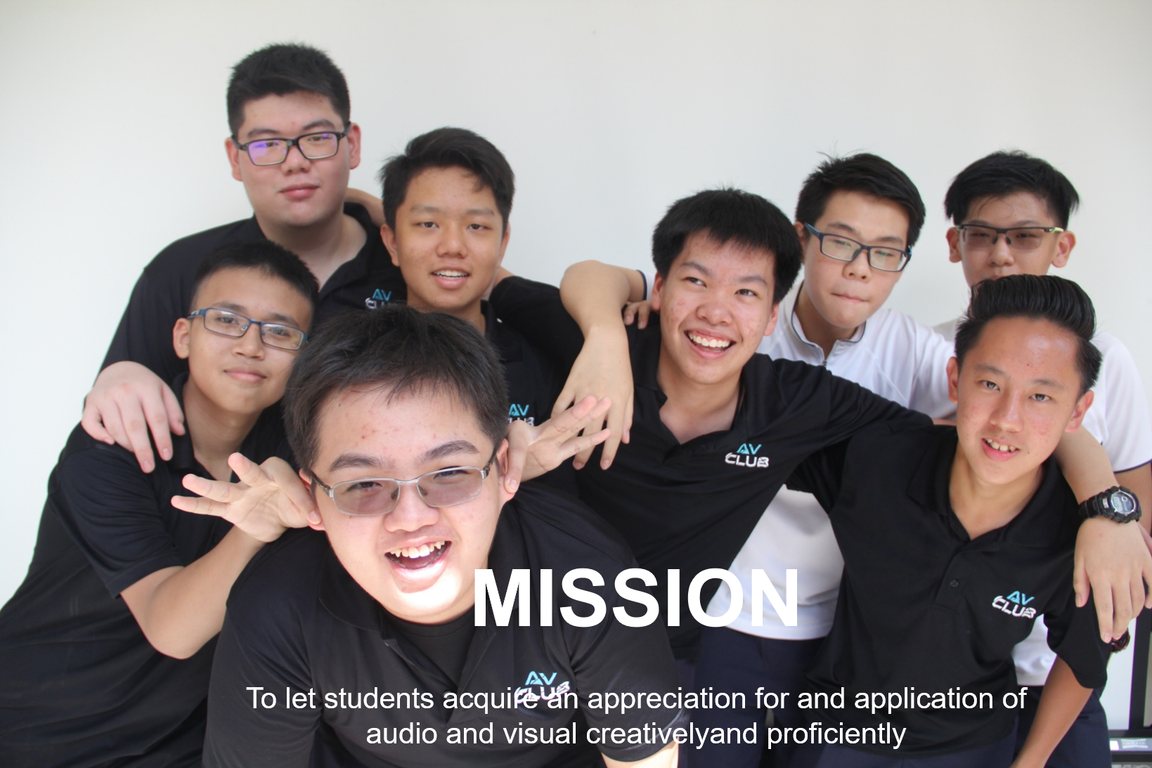 Seven young men in black AV Club shirts pose together smiling, with the word MISSION and a club tagline overlaid.