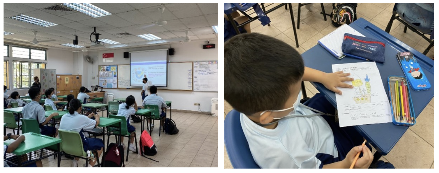 Students in a classroom watch a projected screen while a masked boy works on a colored drawing worksheet with pencils.