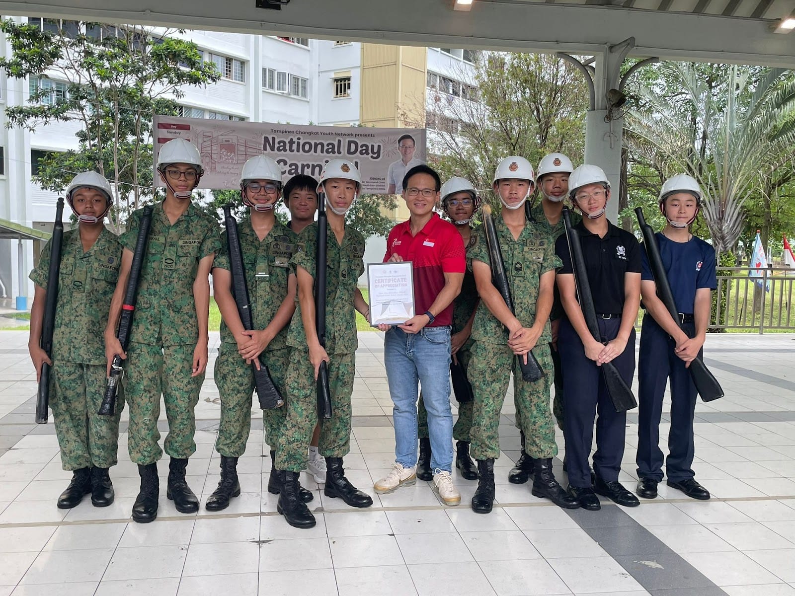 NCC cadets from the Precision Drill Squad being presented with a Certificate of Appreciation for taking part in the National Day Carnival.