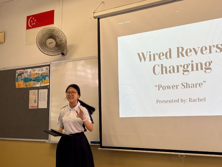 A Ngee Ann Secondary student presenting a slideshow on Wired Reverse Charging.