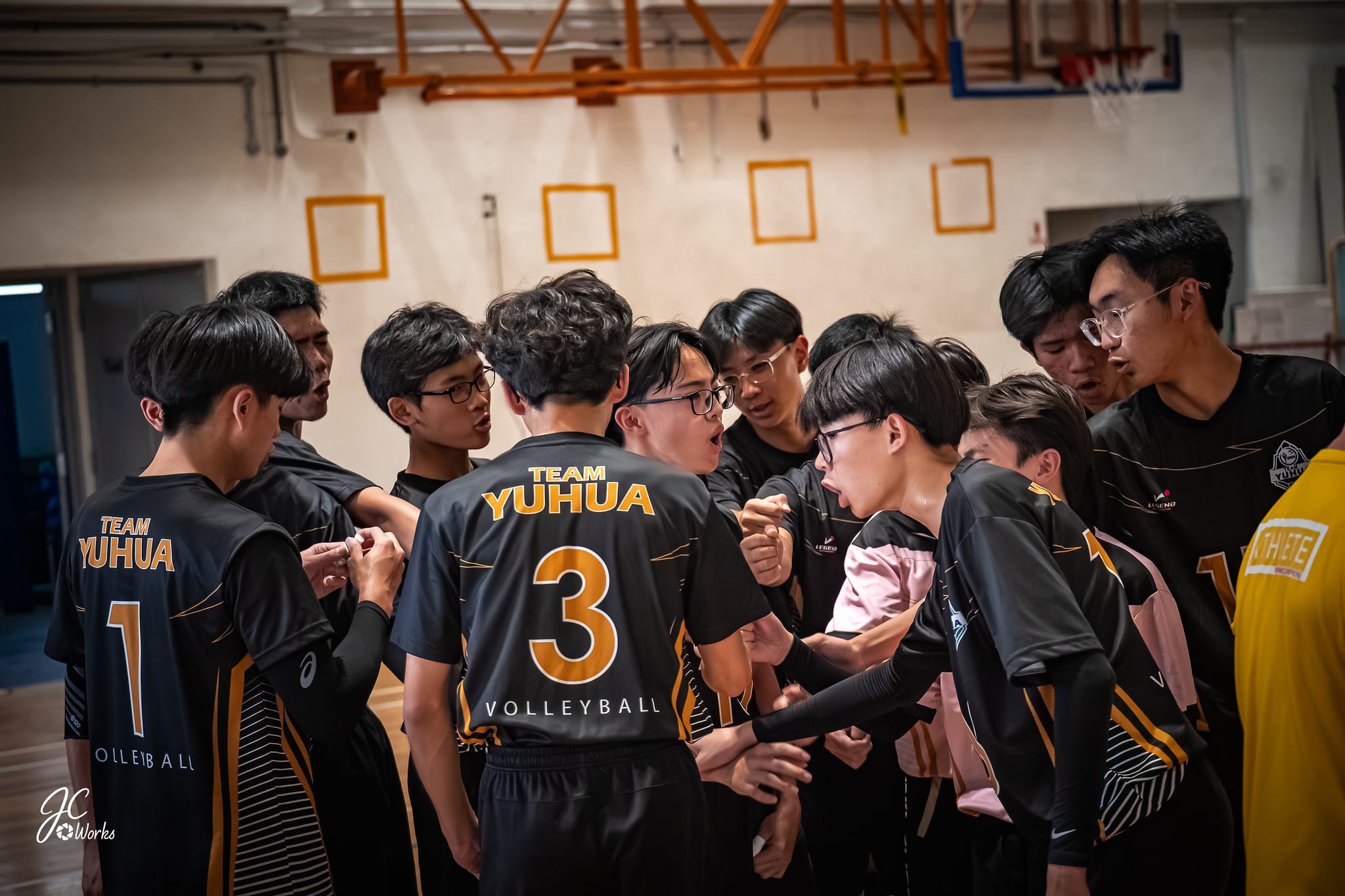 students huddle during volleyball match