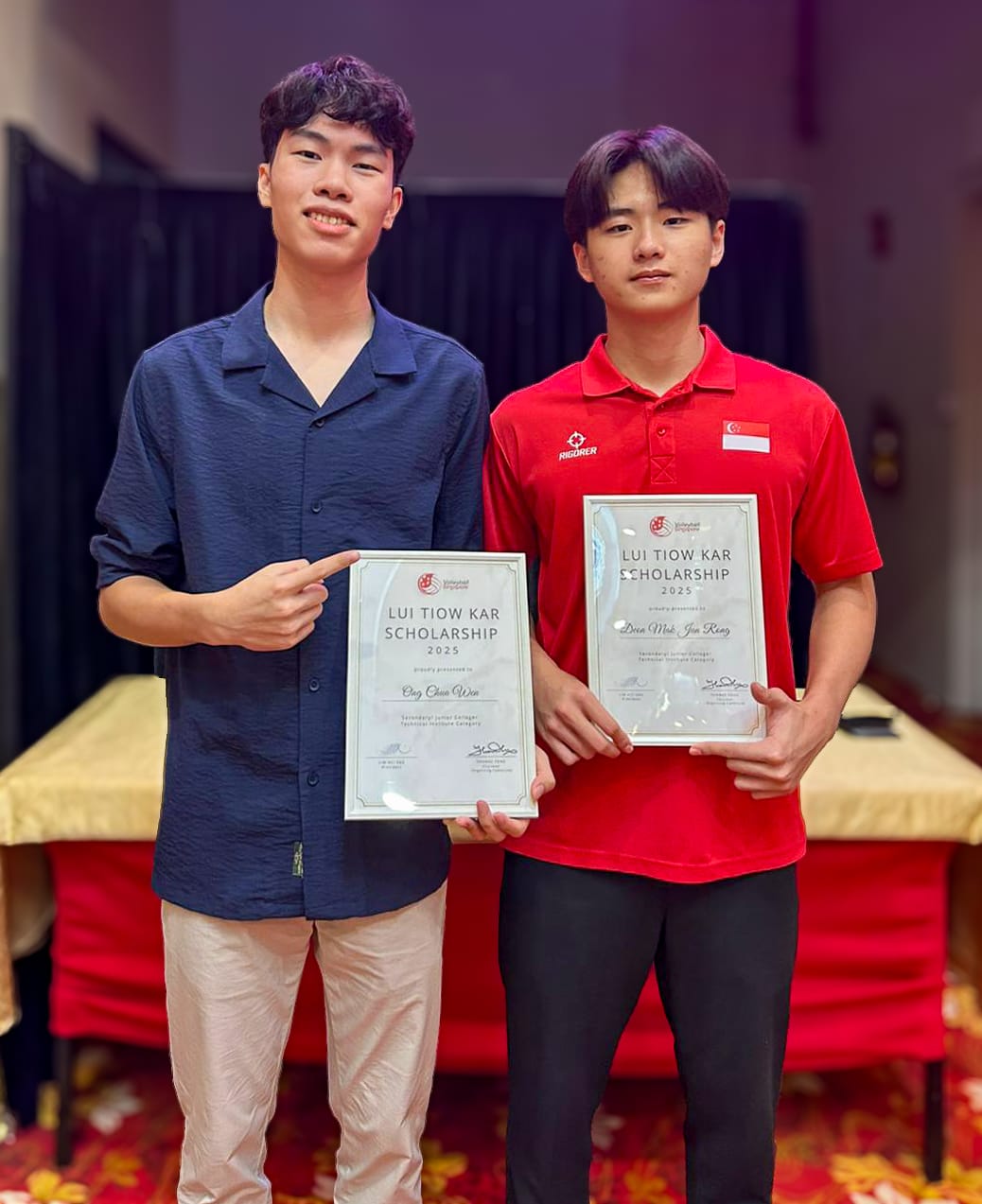 Two young men smiling and holding Lui Tiow Kar Scholarship 2025 certificates indoors.