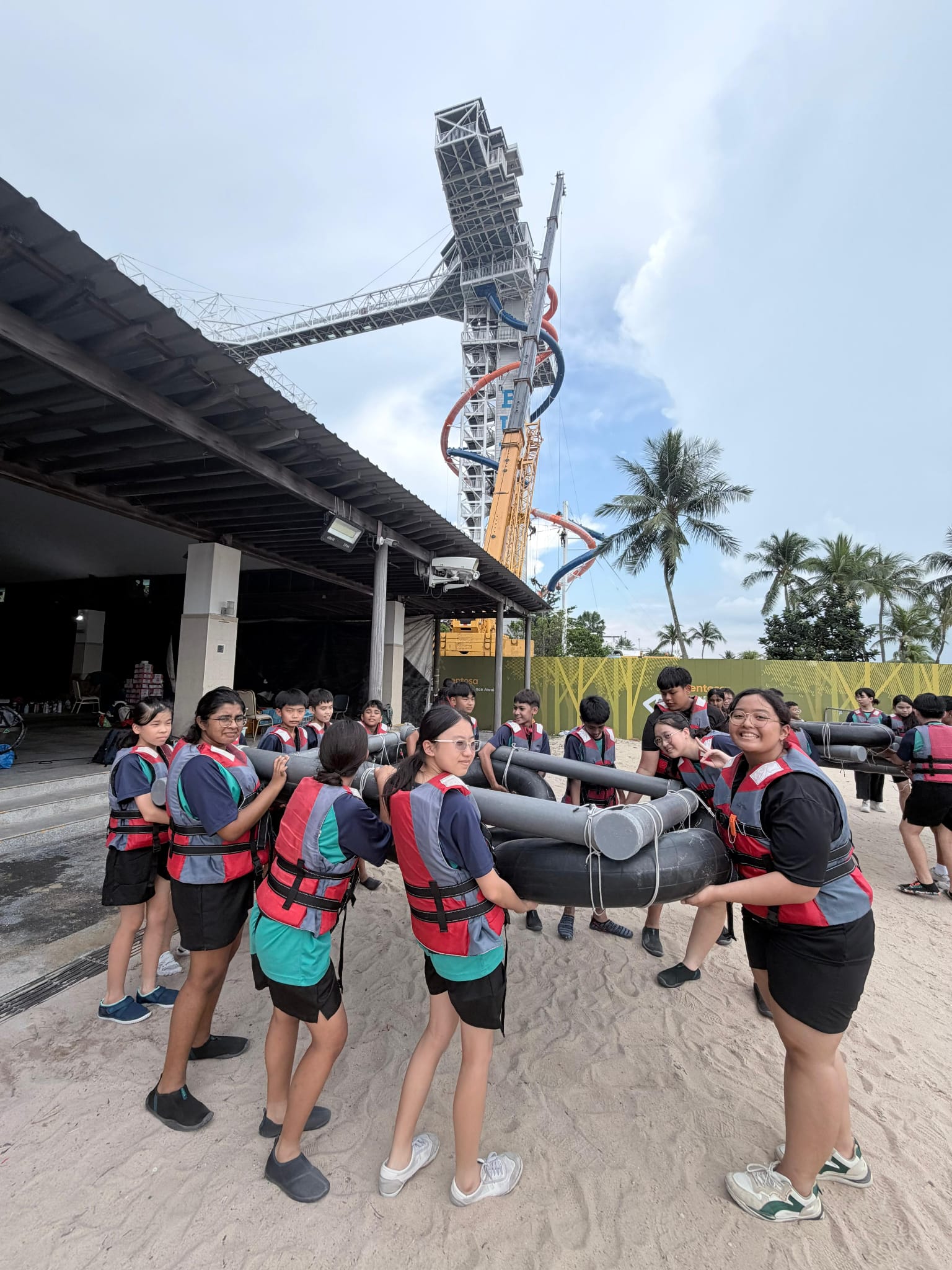 Students carrying a raft