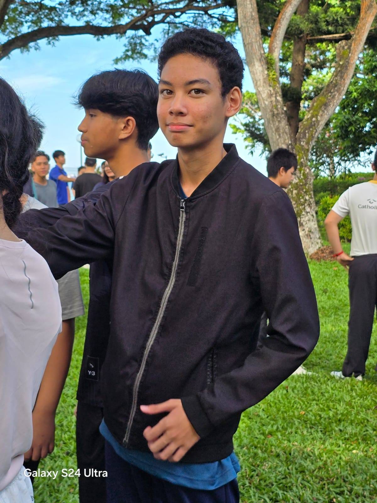 student in jacket posing for a photo