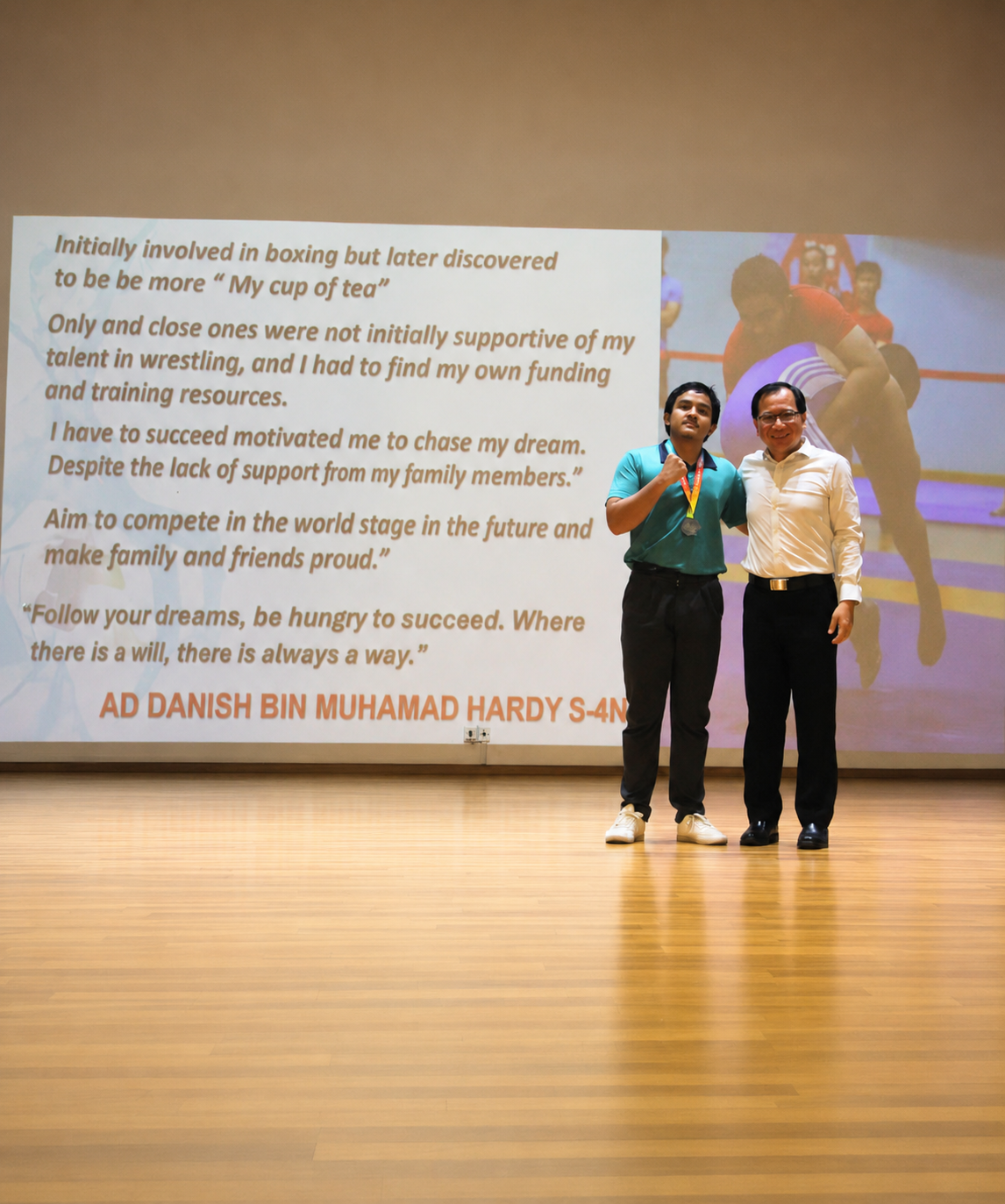 boy and adult stand on stage