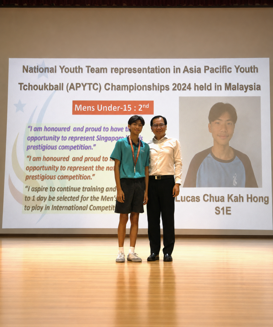 boy and adult stand on stage