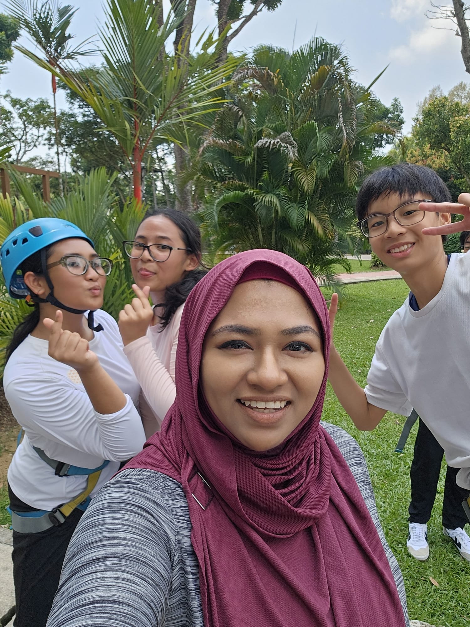 teacher poses with 3 students