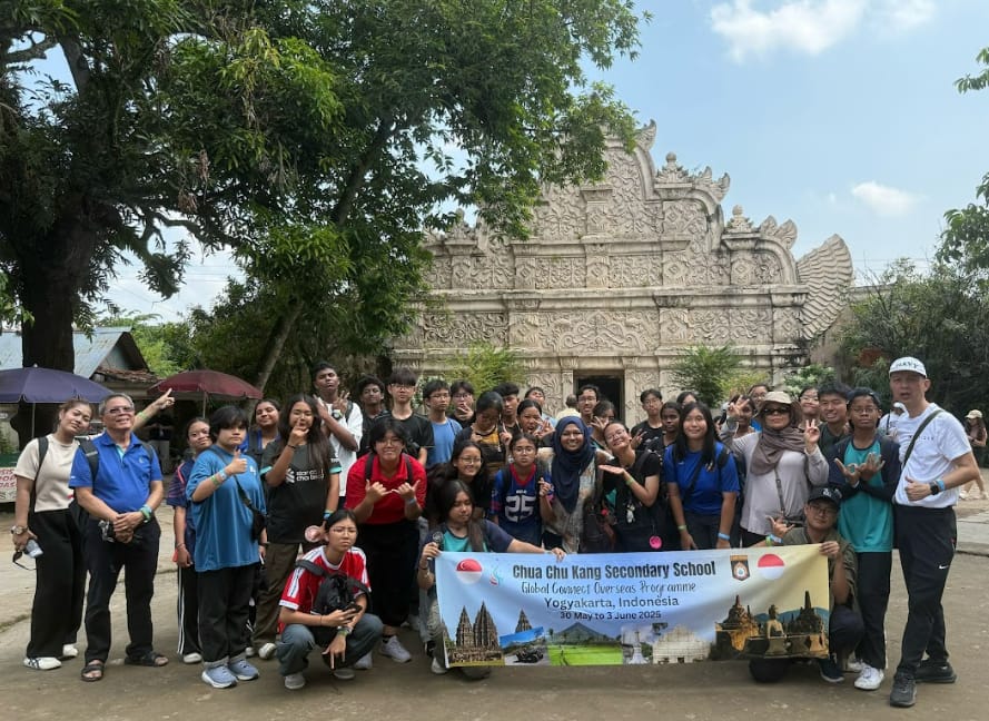 A large student group poses with a banner for Chua Chu Kang Secondary School's overseas trip to Yogyakarta, Indonesia.