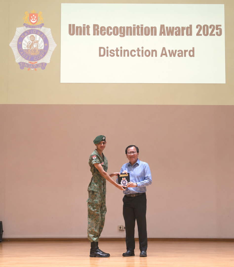 boy presenting award to principal