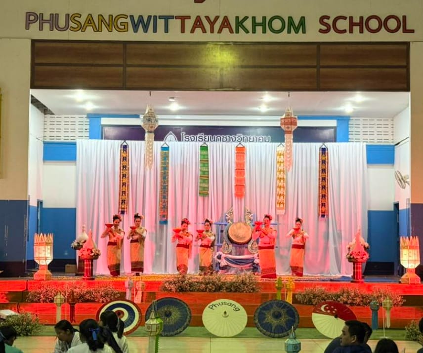 Dancers in traditional Thai costumes perform on a decorated stage at Phusang Wittayakhom School.