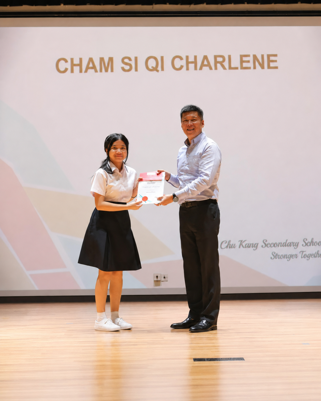 girl receiving prize from man