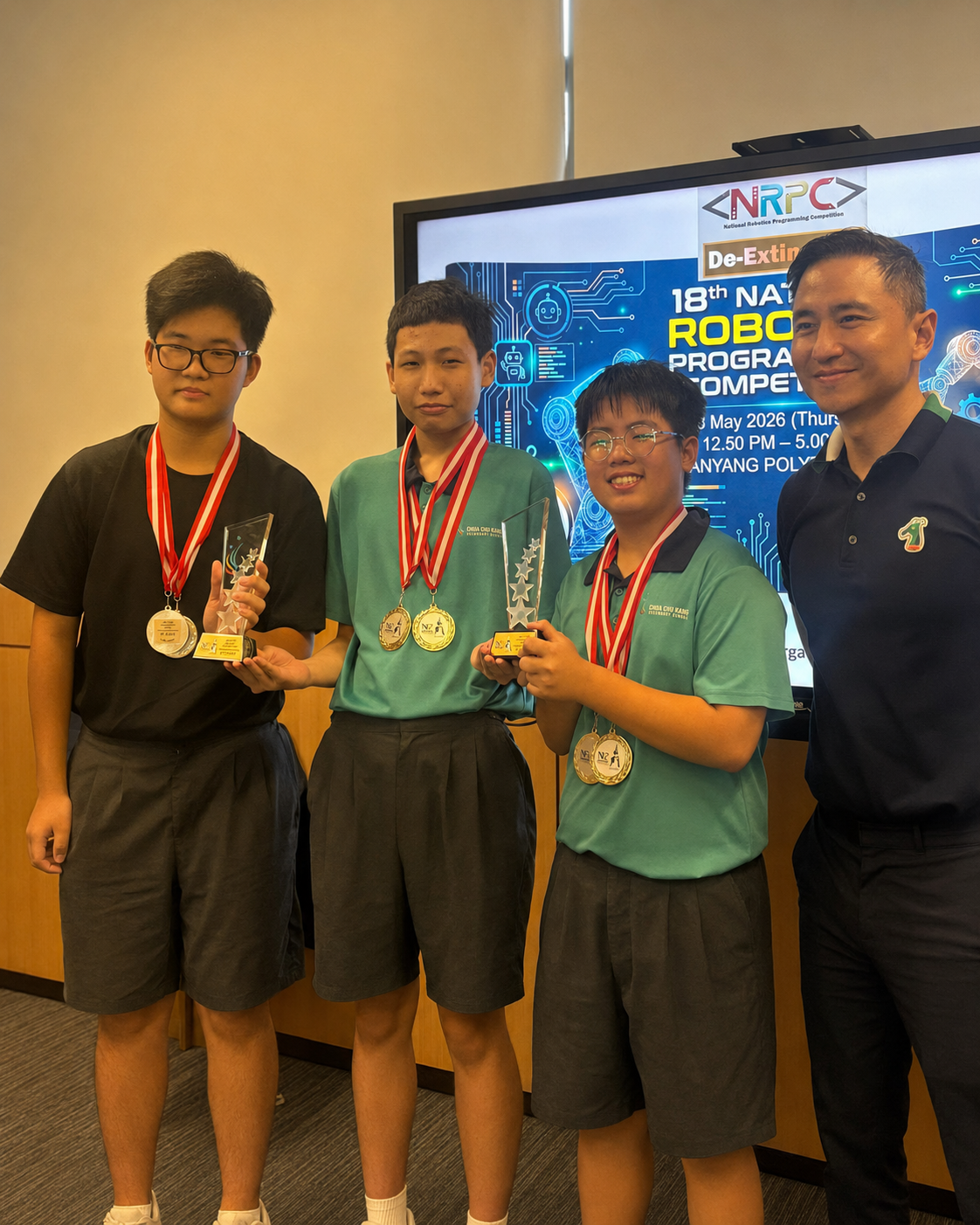 3 boys with medals stand next to a man