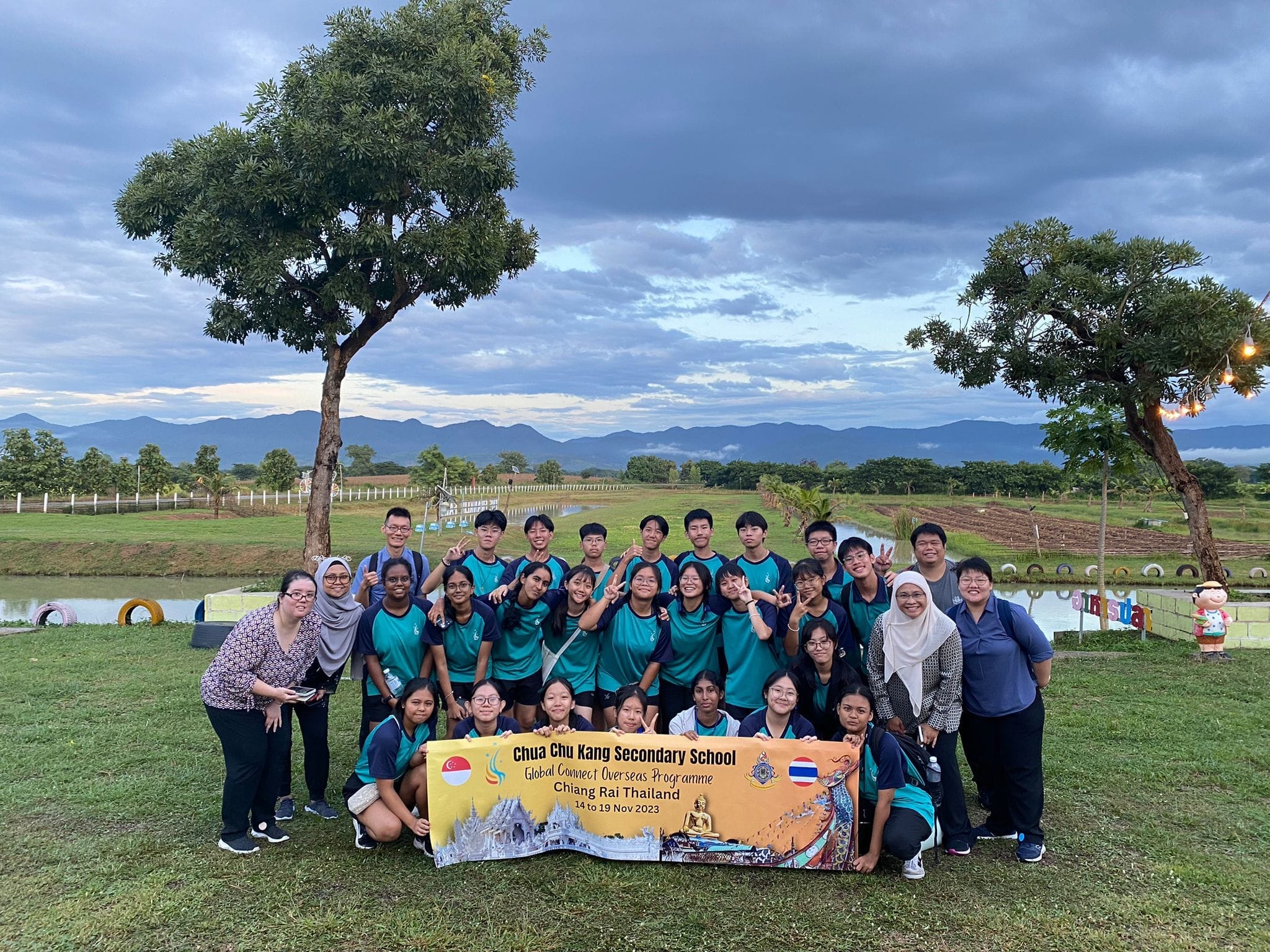 Students and teachers pose for a photo at Chiang Rai airport