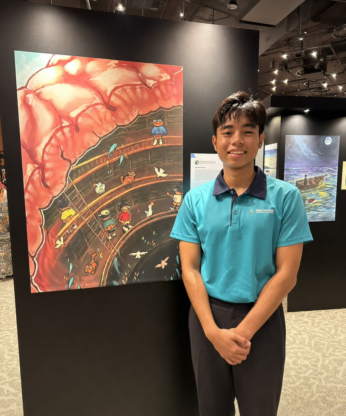 boy standing next to winning art piece