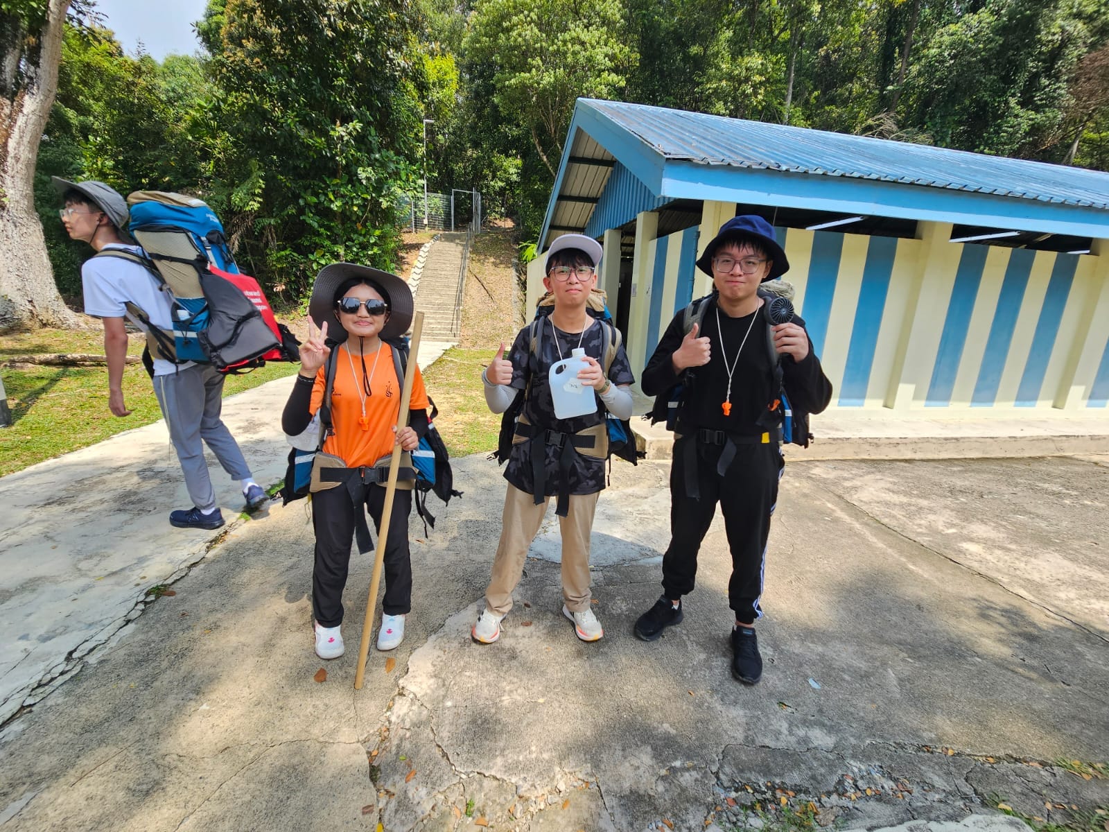 group of 3 students getting ready for a hike