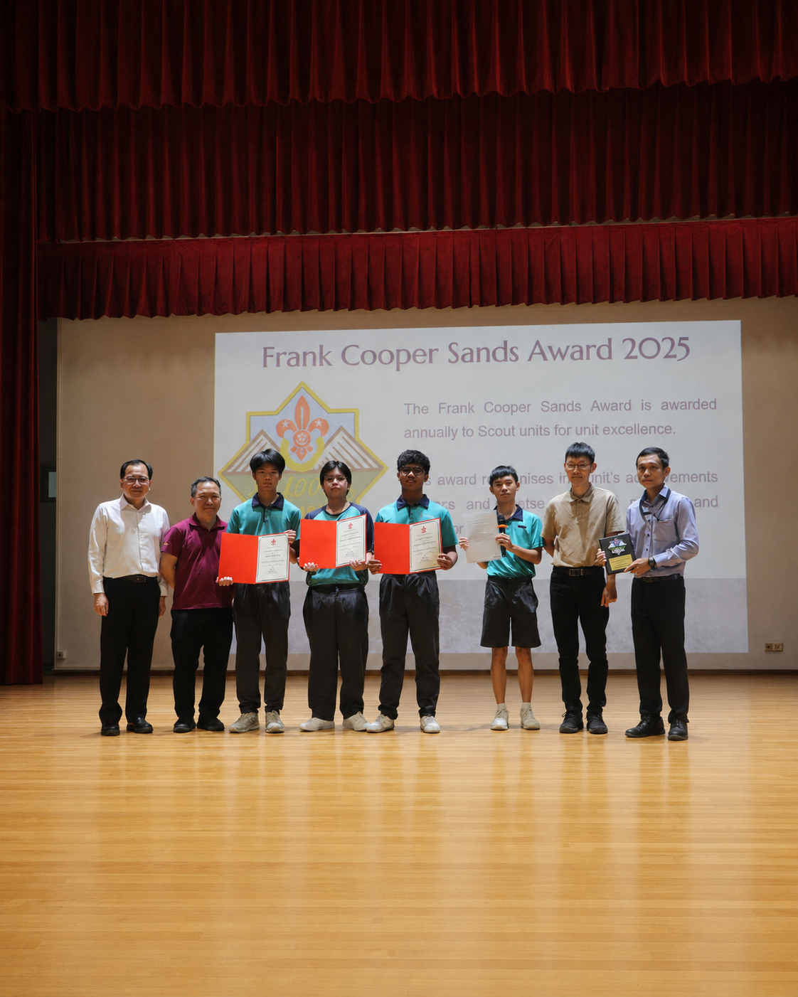 Scouts and teachers on stage with awards