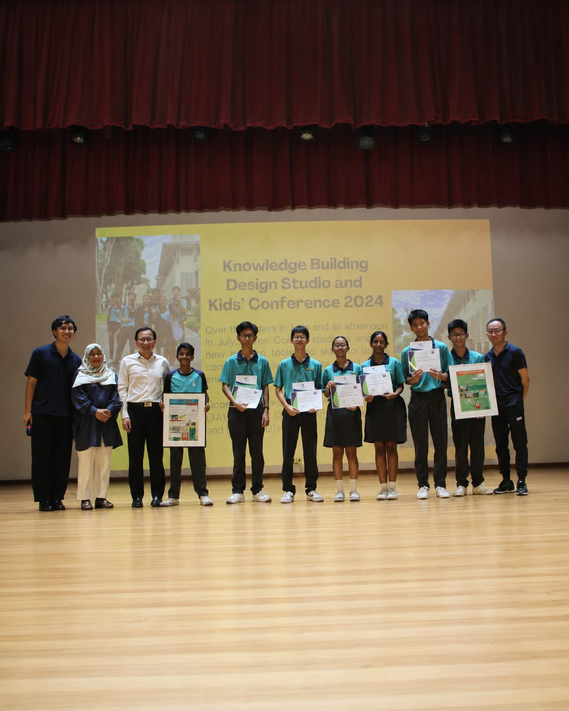 A group of adults and students pose for a photo