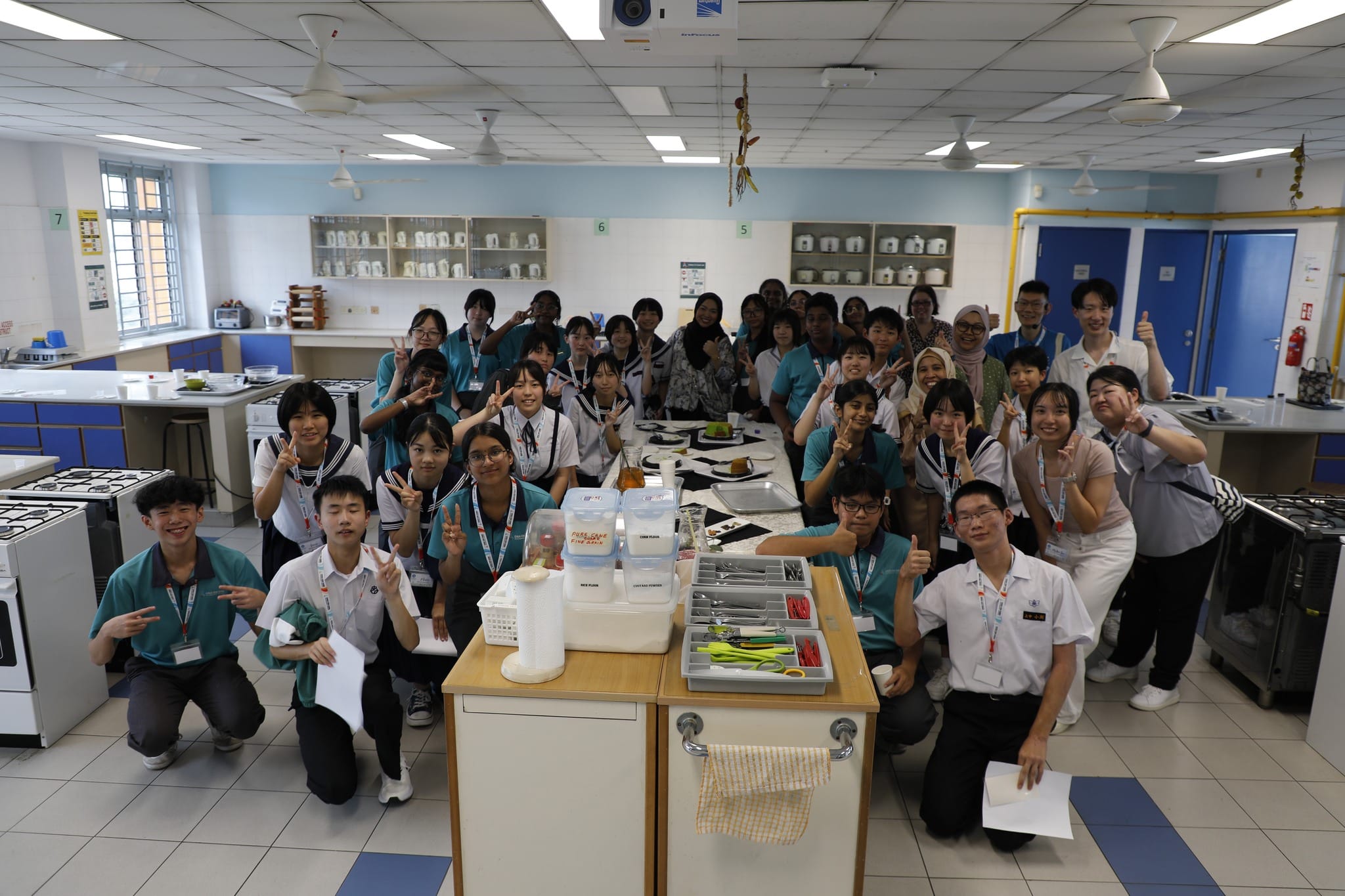 Students posing in a kitchen