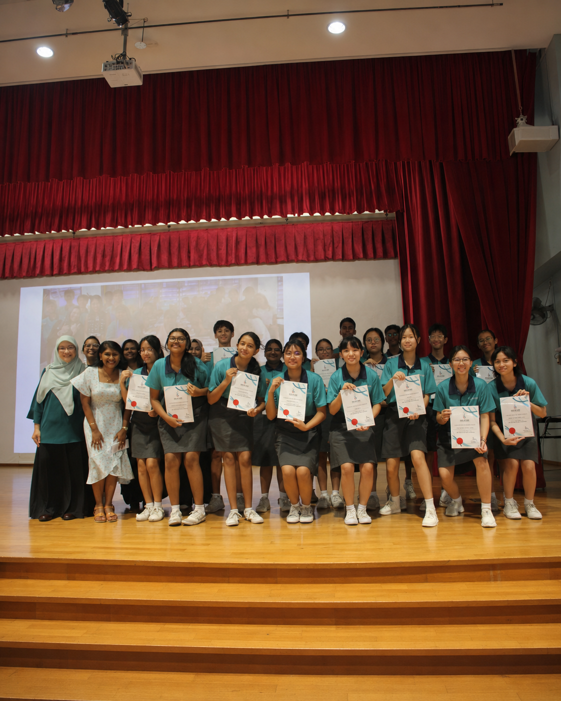 Students standing with certificates from National Day Baking Competition