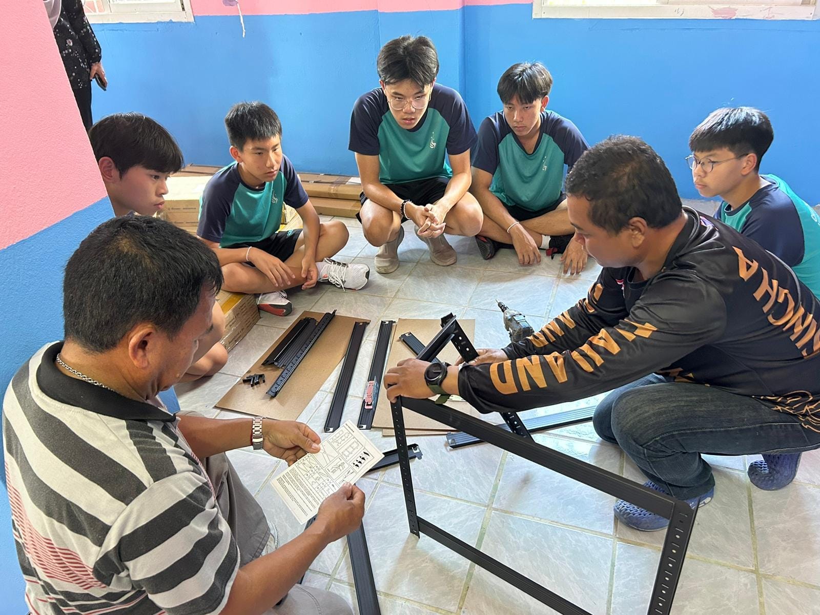 A group of students assembling furniture.