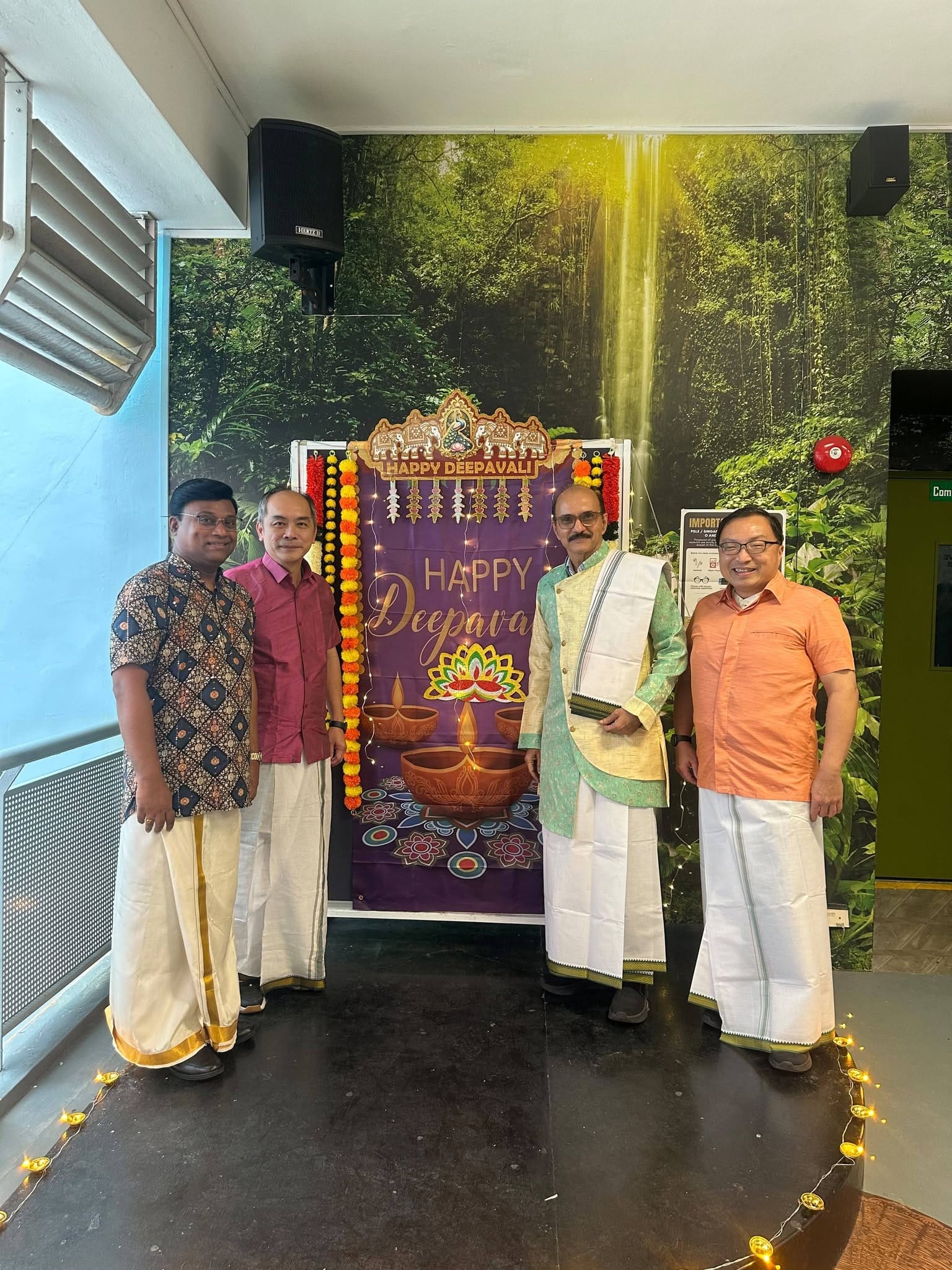 Four men in traditional Indian wear stand together