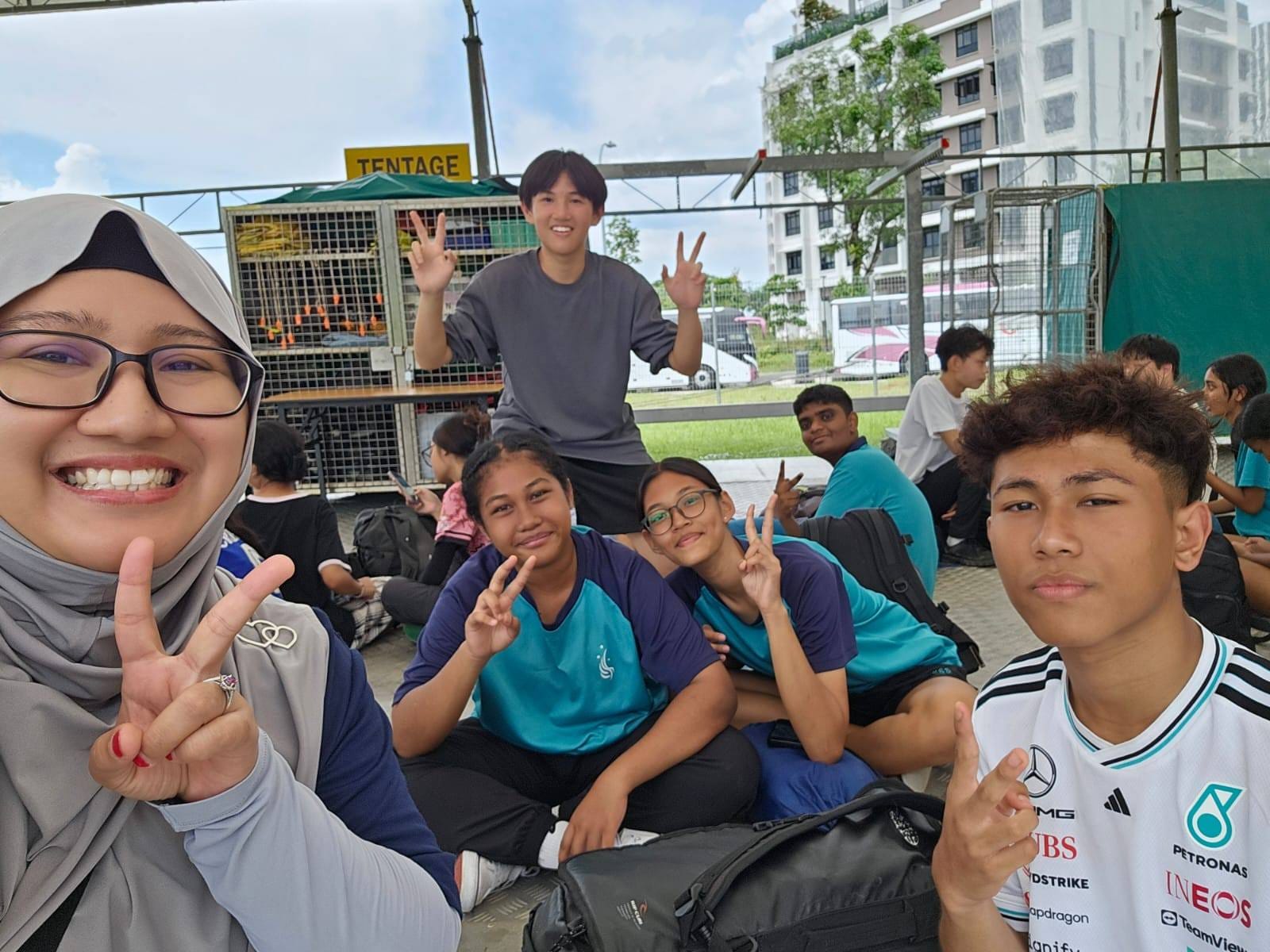 students and for teacher posing for a photo