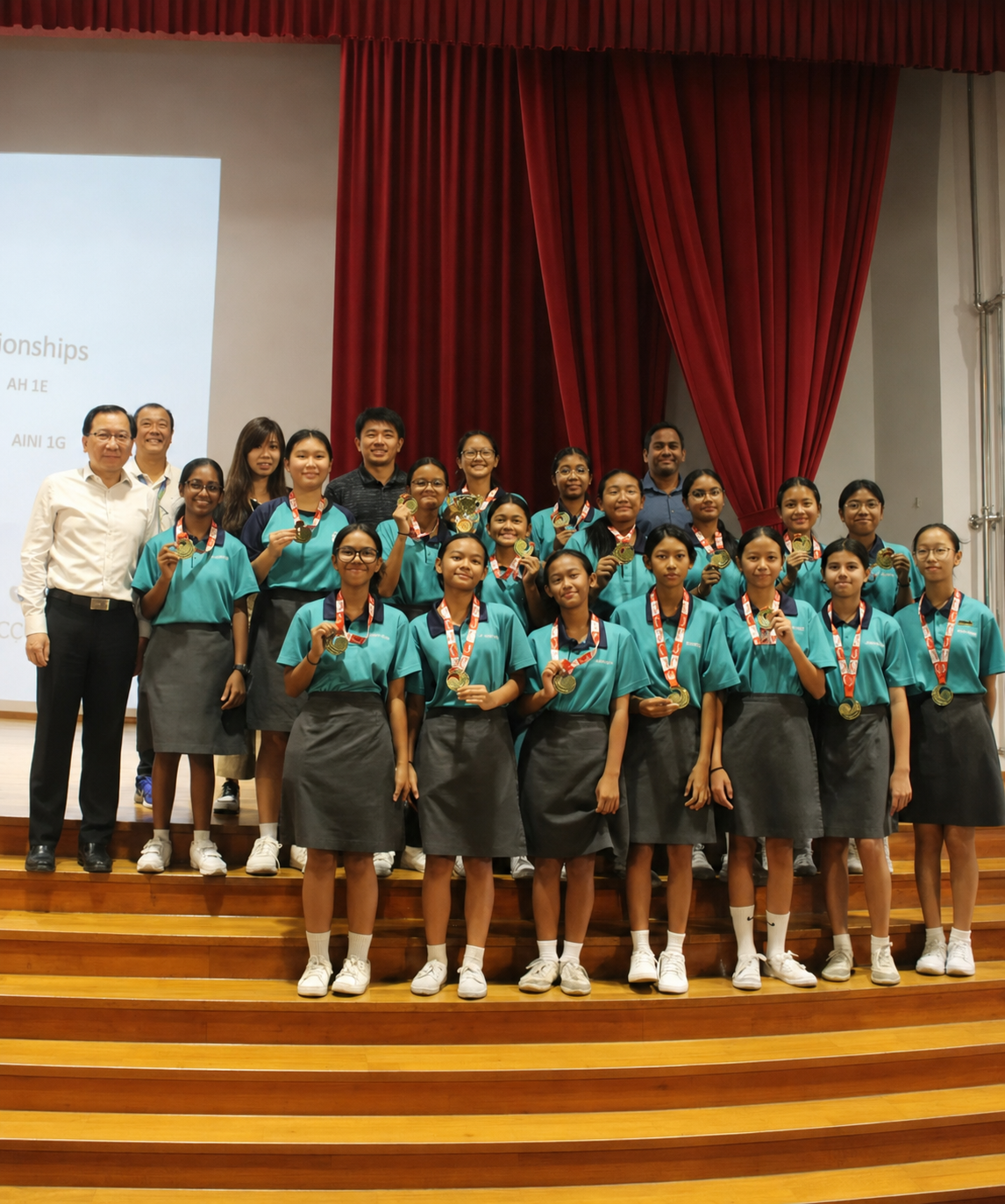 hockey girls posing on stage with their medals