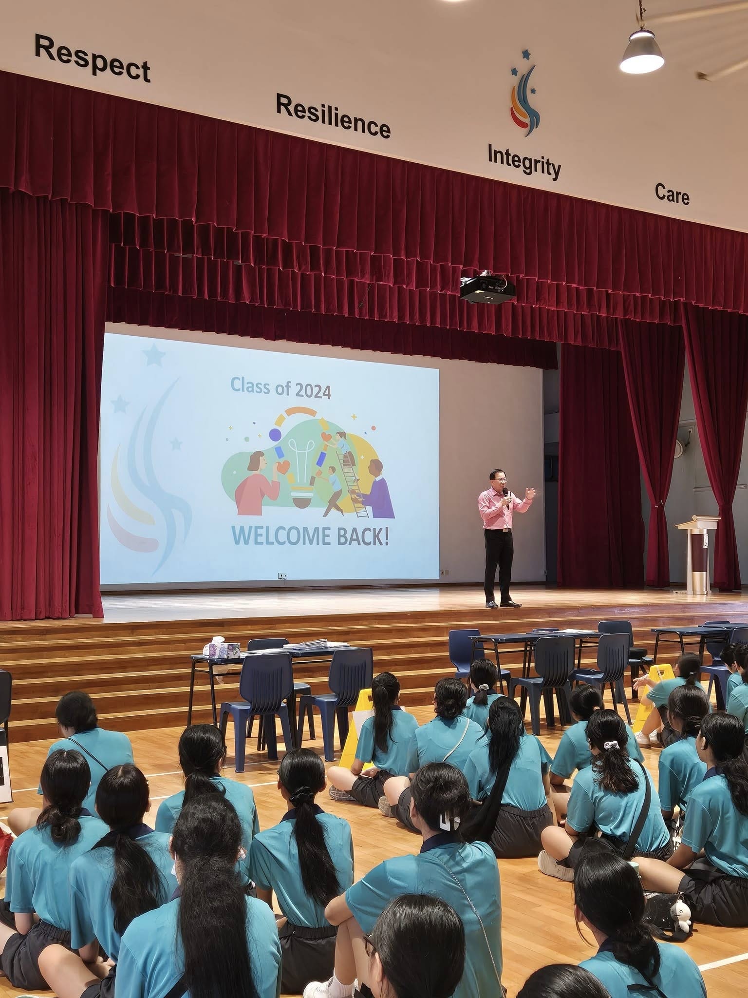 students watching a man on stage
