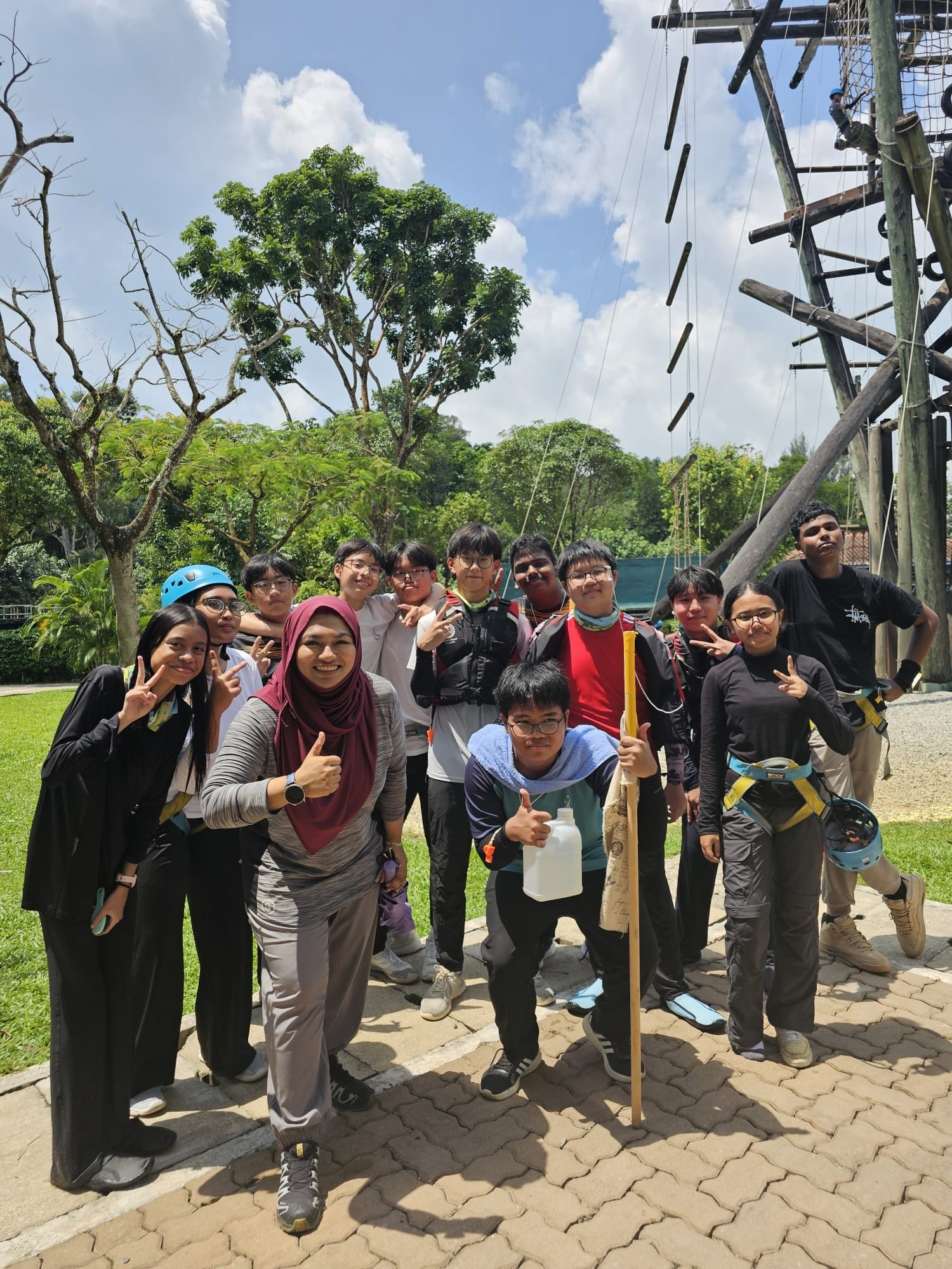 a group of people posing near the high elements