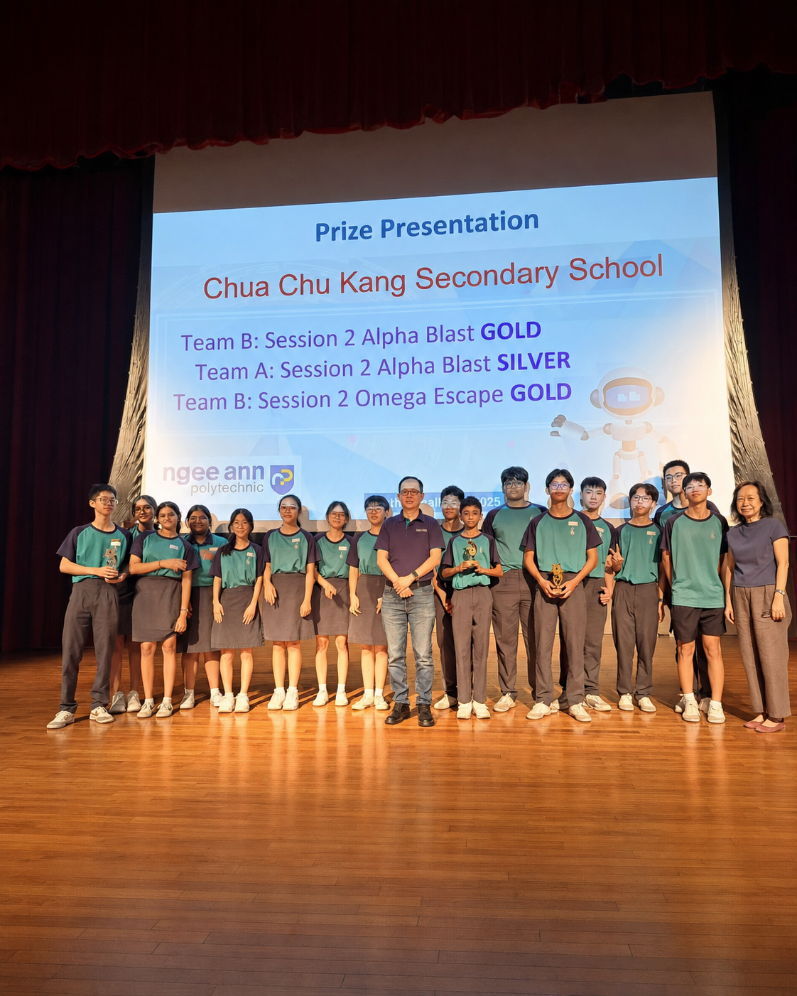 Students and teachers from Chua Chu Kang Secondary School pose on stage during a prize presentation at Ngee Ann Polytechnic.