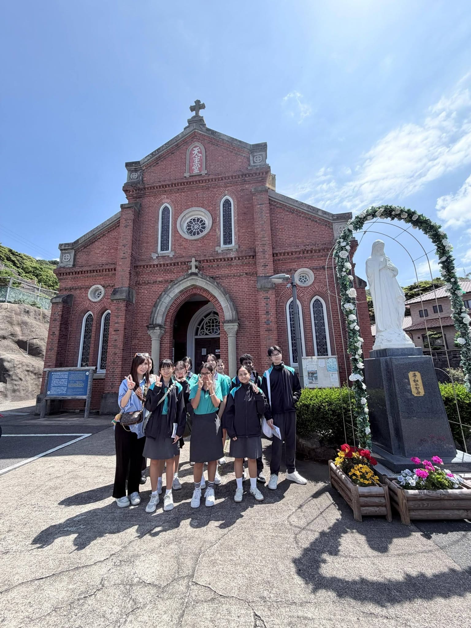 Students pose in front of a brick church